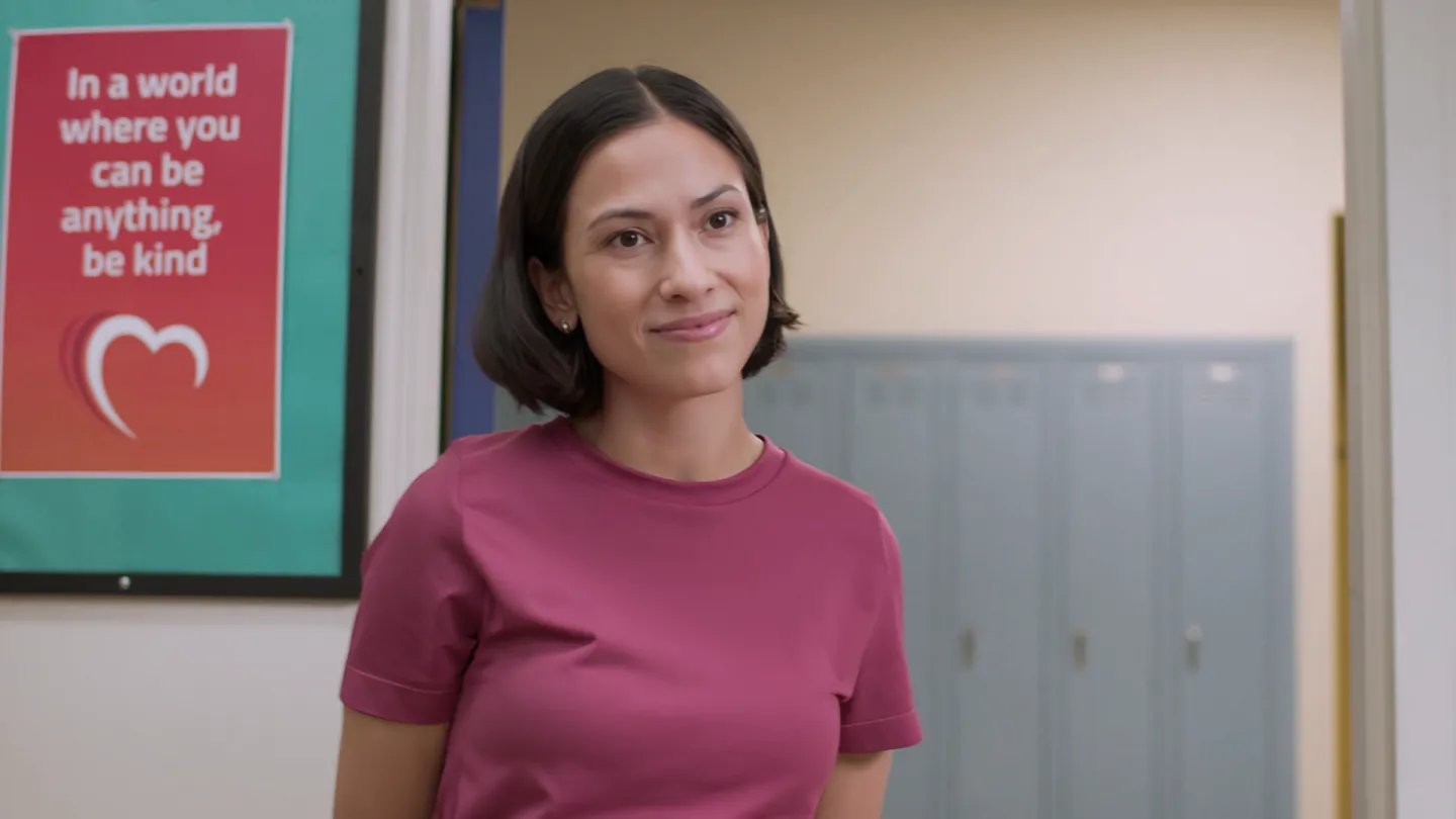 A teacher smiles confidently.